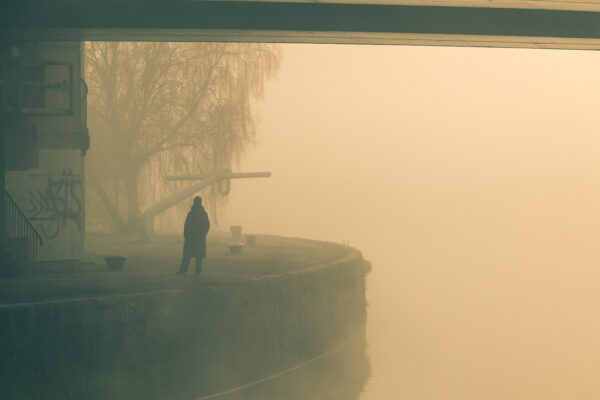 A lone figure walks below the Plimsoll Bridge on a foggy February day